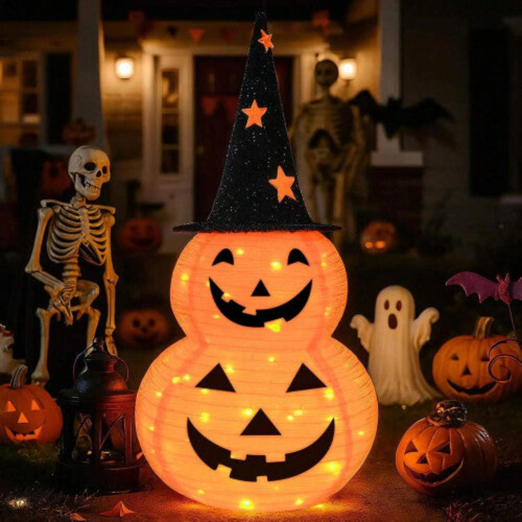 A deep sapphire collapsible fabric Jack-o-lantern pumpkin light displayed on a decorated outdoor porch step.