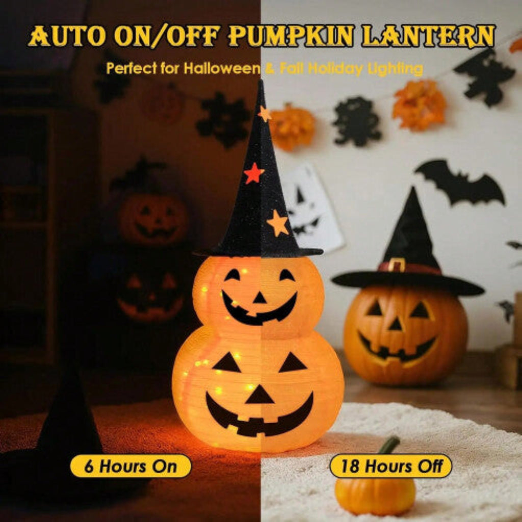 A deep sapphire collapsible fabric Jack-o-lantern pumpkin light displayed on a decorated outdoor porch step.