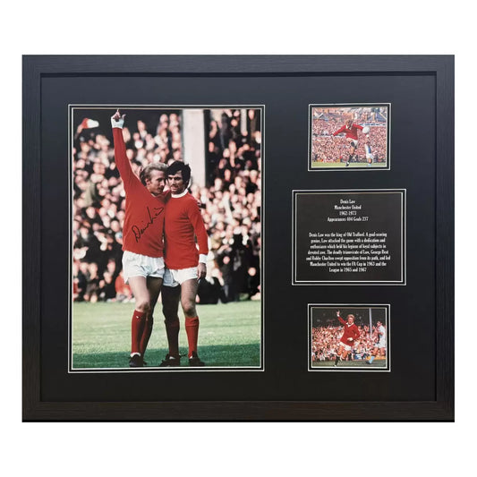 A framed, authentic 16x12 photograph of Denis Law in a Manchester United kit, displayed in a professional black frame against a neutral background.