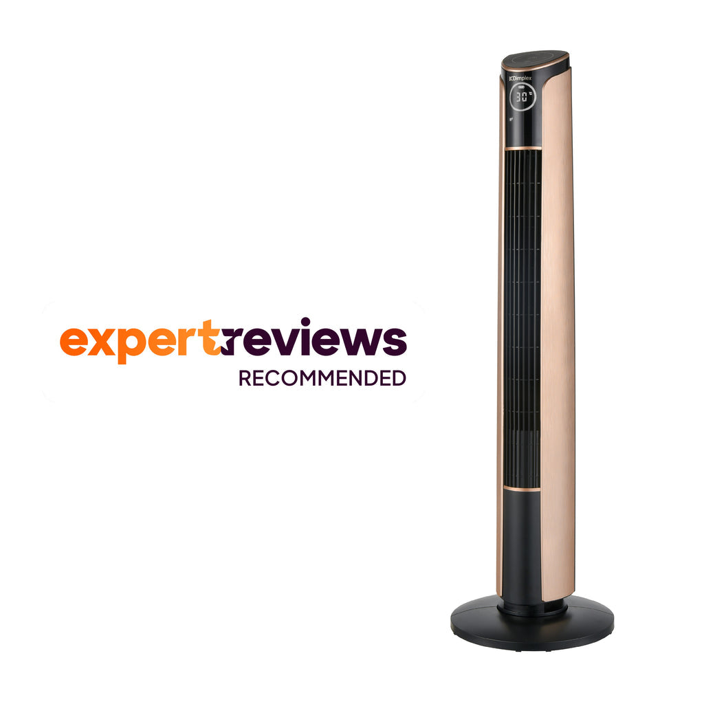 A tall, slender black and copper Dimplex Ion Fresh tower fan standing elegantly on a hardwood floor next to a modern armchair.