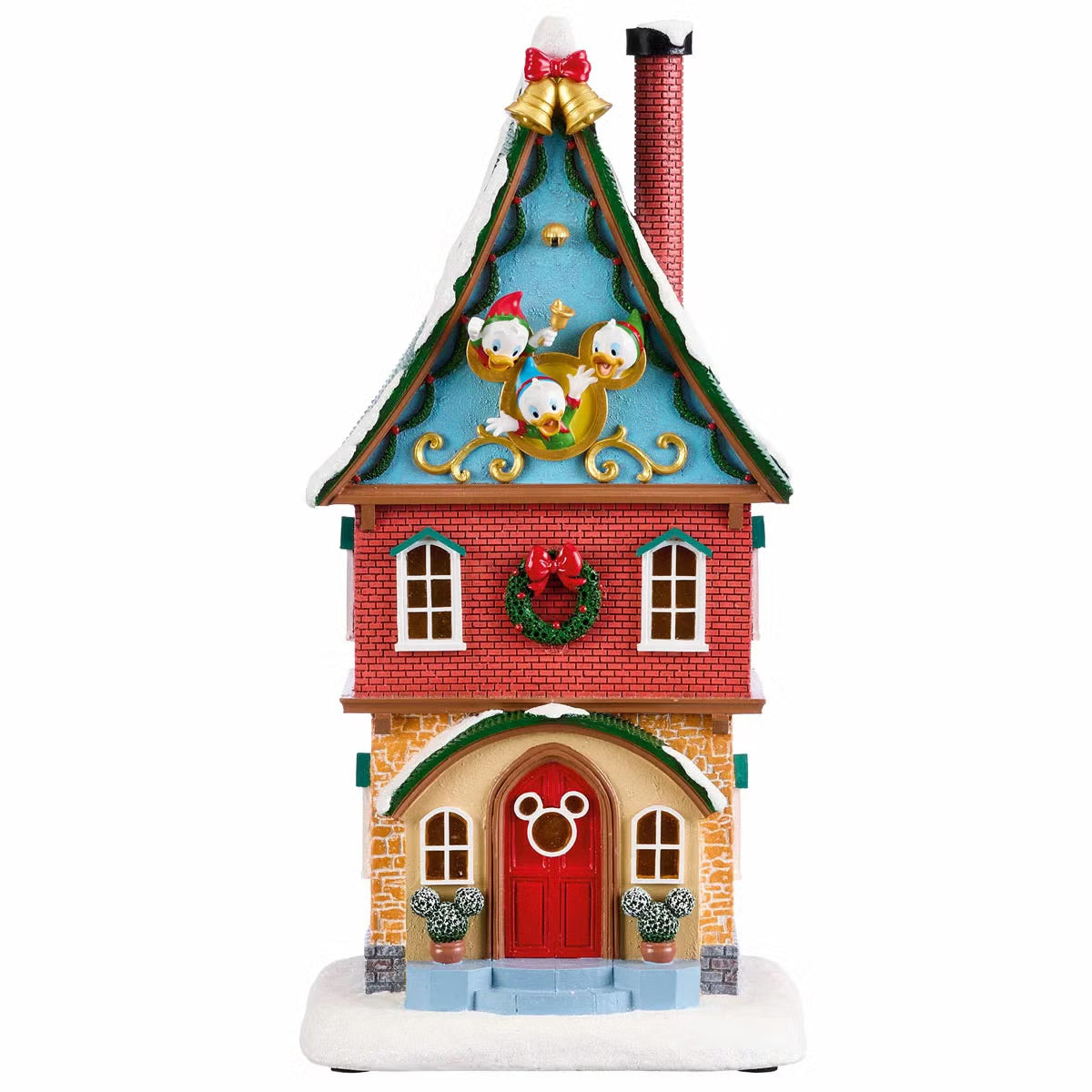 Complete 13-piece lighted Disney Christmas village featuring hand-painted Mickey Mouse figures, glowing LED snow-covered houses, and illuminated archway on a wooden table.