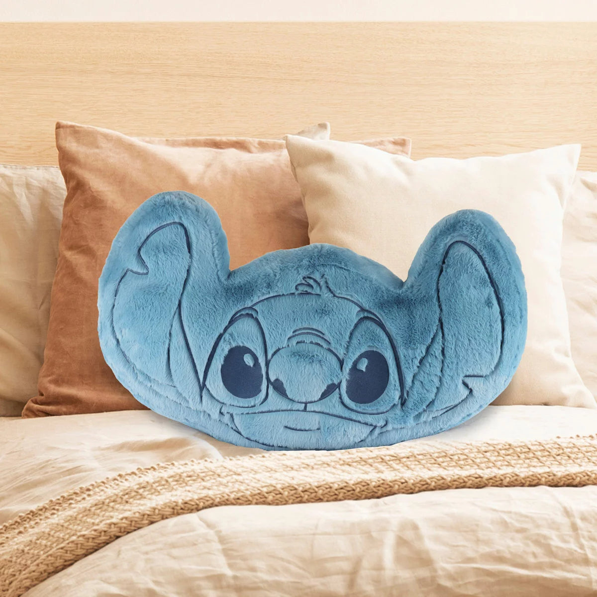 Soft Stitch character shaped oversized cushion crafted from plush faux rabbit fur resting on a cozy child's bed.