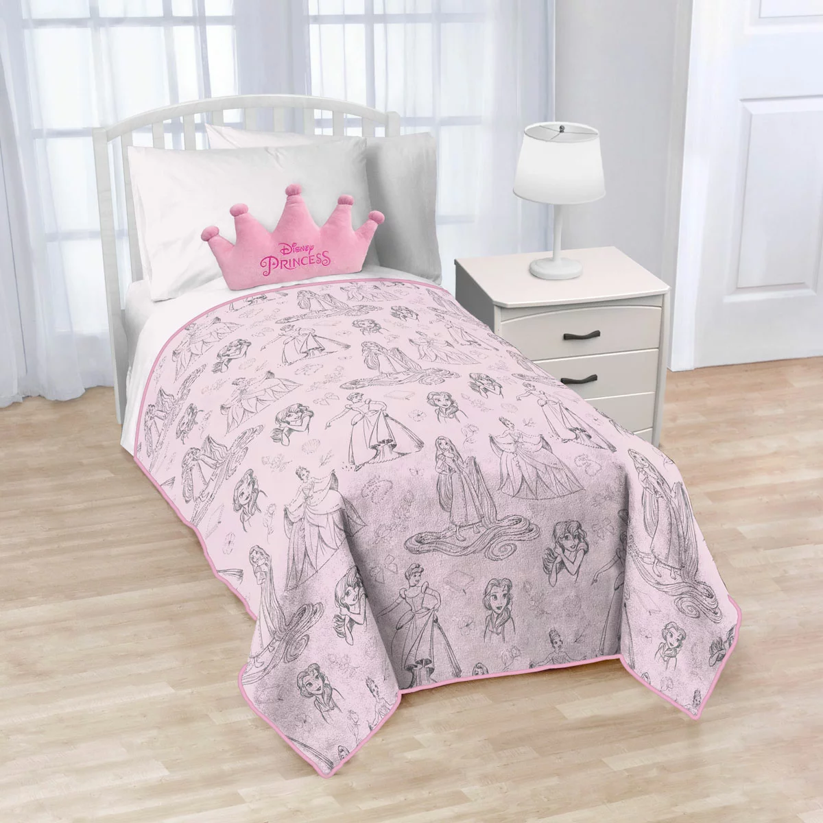 Disney Princess plush blanket and character-shaped Nogginz cushion set displayed together on a child's bed.