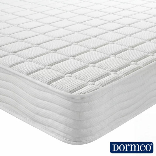 Dormeo Memory Plus Rolled Mattress expanding on a modern wooden bed frame in a brightly lit bedroom setting.