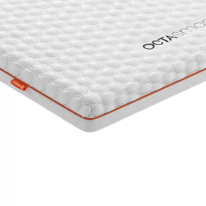 Dormeo Octasmart Deluxe Memory Foam Mattress Topper showing layered honeycomb Octaspring core on a modern bed setup.