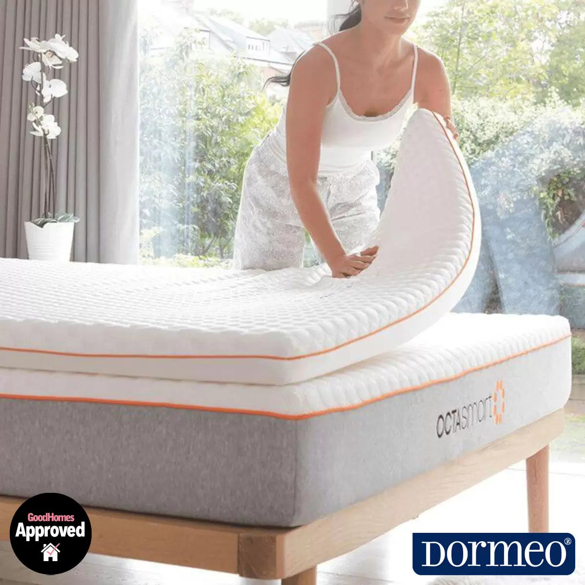 Top angle of open-cell Dormeo Octasmart Plus Mattress Topper showing breathable white cover fabric and inner honeycombed spring structure on a modern bed setup.