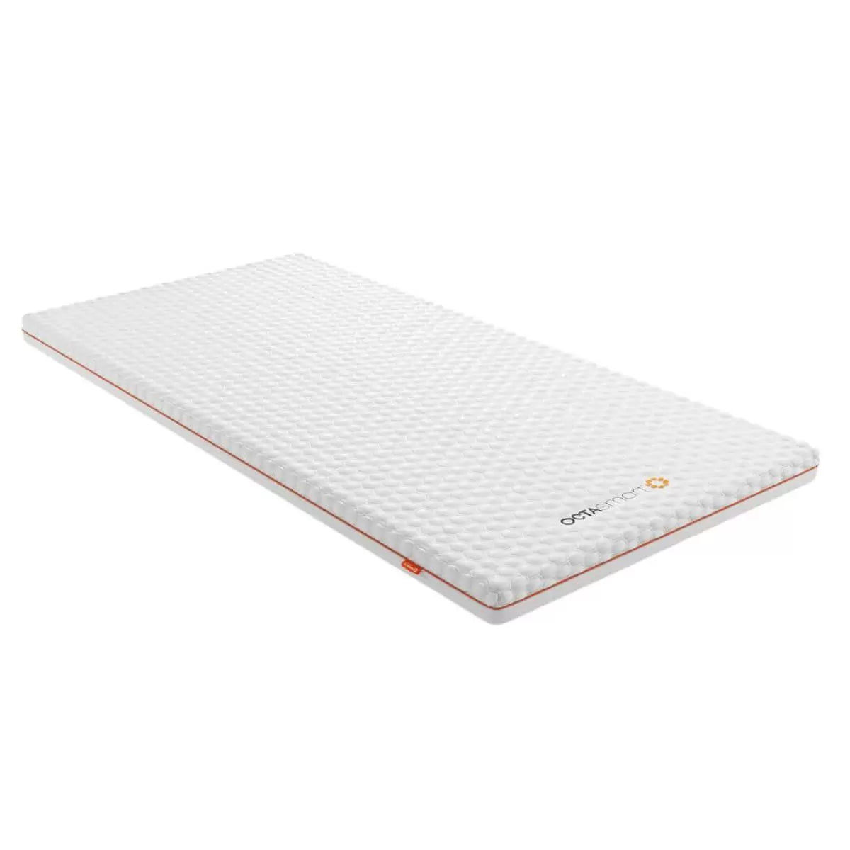 Top angle of open-cell Dormeo Octasmart Plus Mattress Topper showing breathable white cover fabric and inner honeycombed spring structure on a modern bed setup.