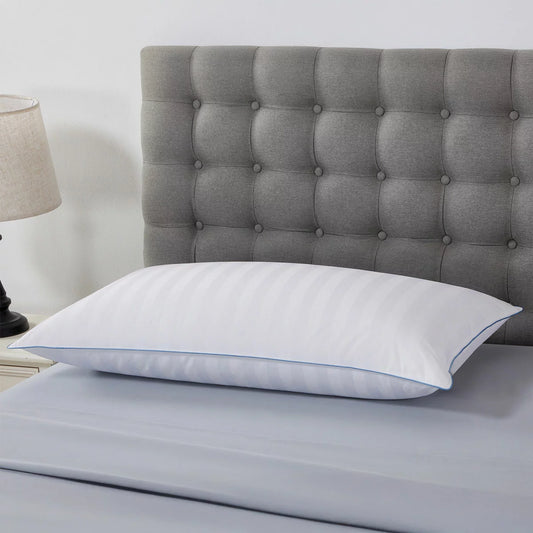 Crisp white Down Haven king size duck down pillow featuring a subtle striped 500 thread count cotton cover resting on a neatly dressed king bed.