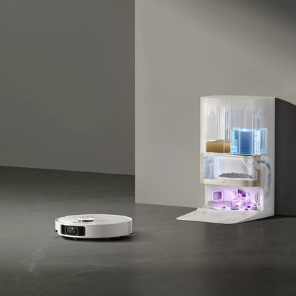 Front angle view of the sleek black Dreame X40 Ultra Complete robot vacuum parked inside its tall self-cleaning dock on a polished hardwood floor.