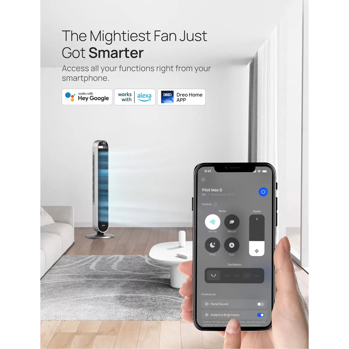 Silver Dreo Pilot Max DR-HTF004S smart tower fan standing upright on a dark hardwood floor against a minimalist white living room wall.