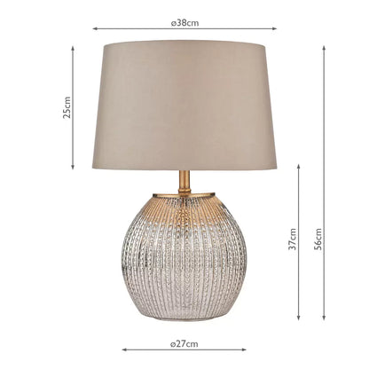 Sonia dual light table lamp featuring a glowing antique silver glass base and a warm taupe tapered fabric shade placed on a dark wood living room side table.