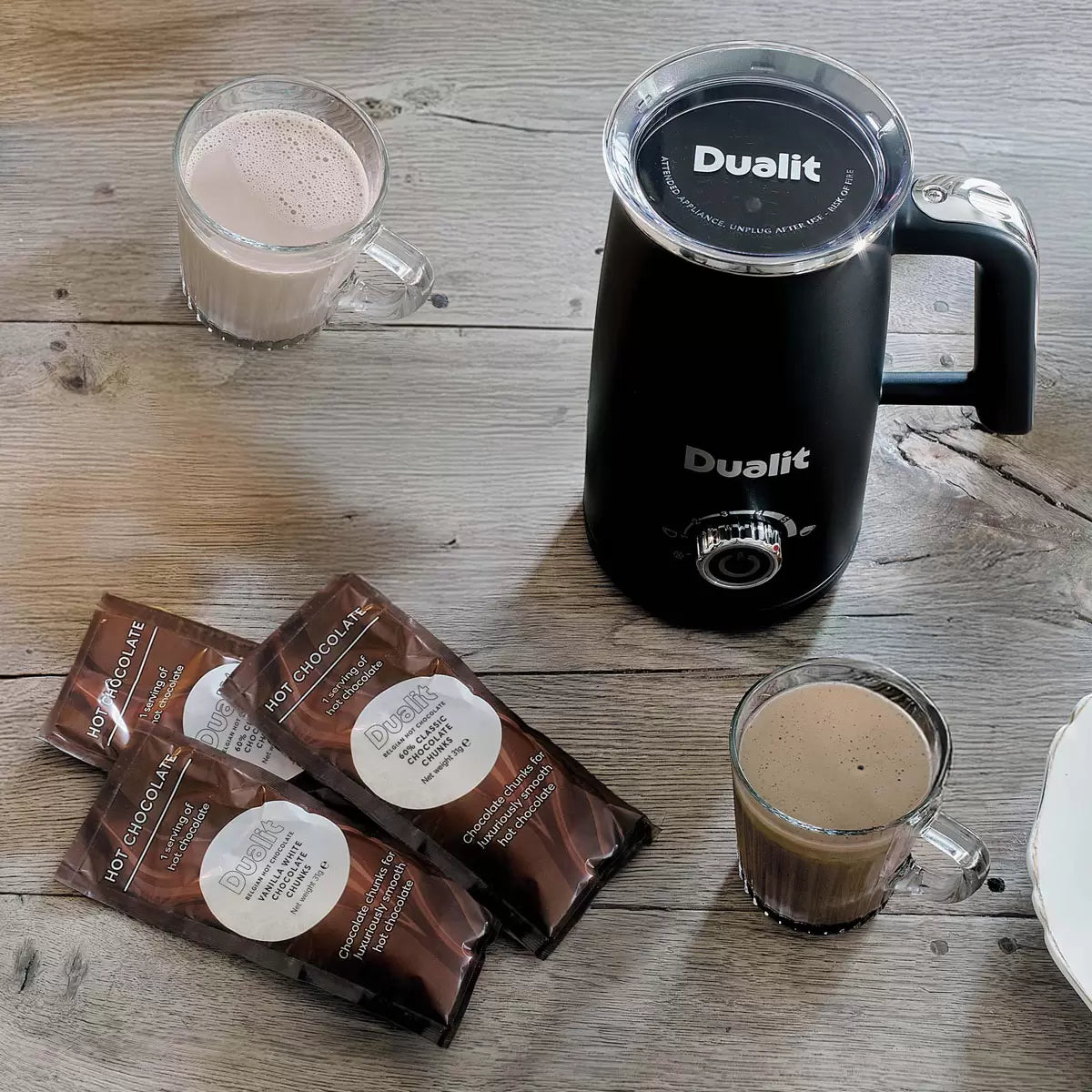 Dualit Milk Frother & Hot Chocolate Maker Max with Belgian chocolate sachets making creamy café-style hot drinks.
