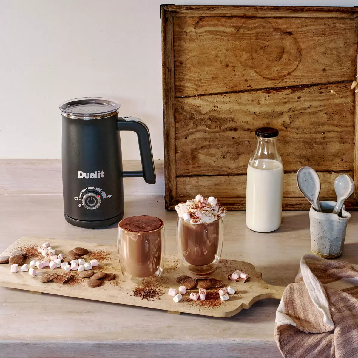 Dualit Milk Frother & Hot Chocolate Maker Max with Belgian chocolate sachets making creamy café-style hot drinks.