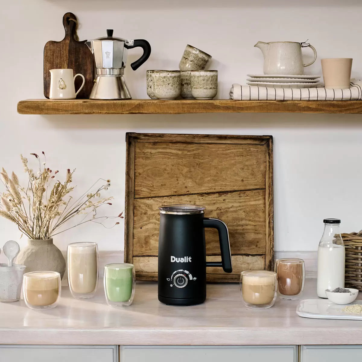 Dualit Milk Frother & Hot Chocolate Maker Max with Belgian chocolate sachets making creamy café-style hot drinks.