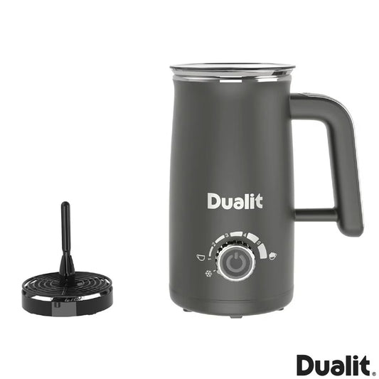 Front view of the grey Dualit Milk Frother Max displaying the froth adjustment dial, non-drip spout, and cool-touch body on a modern kitchen countertop.