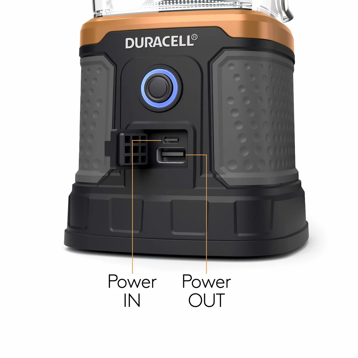 Rugged black Duracell 3000 lumen outdoor lantern sitting on a dark wooden picnic table with its top solar panel and wireless charging port illuminated.