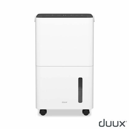 Front view of the white Duux Bora 12L dehumidifier standing on a modern wooden floor next to a laundry airer, highlighting its sleek digital display panel.
