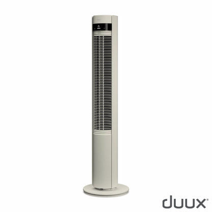 Duux Elevate tower fan with its telescopic height-adjustable feature extended in a modern living room setting.