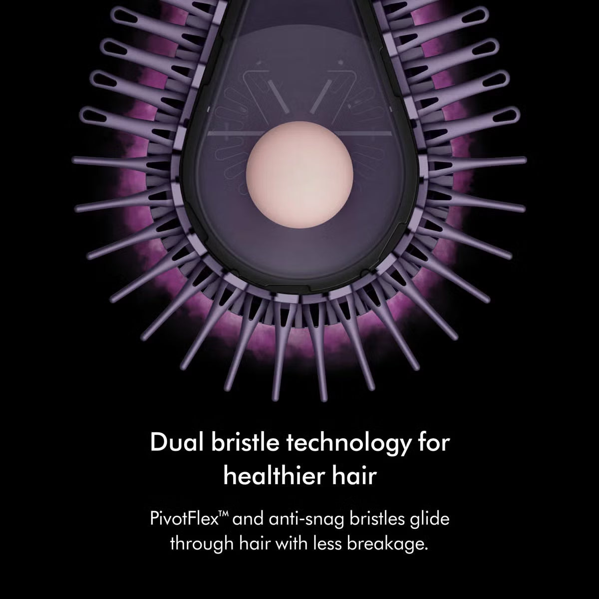 Dyson Airsmooth styling brush in Ceramic Pink with teardrop brush head and soft dual bristles sitting on a vanity table.