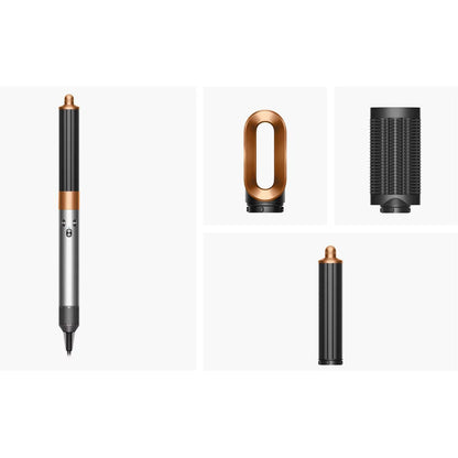 Dyson Airwrap Origin in Nickel/Copper finish, featuring the long curling barrel and loop brush attachments arranged neatly on a modern vanity.