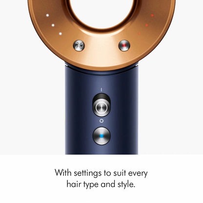 Dyson Supersonic Hair Dryer in Prussian Blue and Rich Copper finish, shown with the styling concentrator, flyaway, and gentle air attachments on a neutral background.