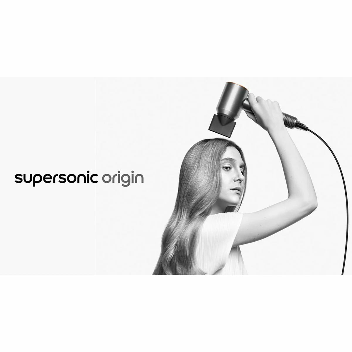Dyson Supersonic Origin hair dryer in a sleek nickel and copper finish showing its iconic hollow head design and magnetic styling concentrator.