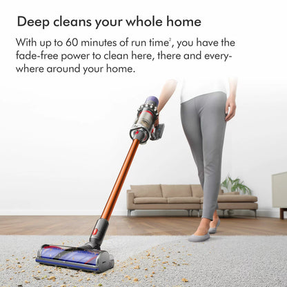 Profile view of the nickel and copper Dyson V10 Submarine cordless wet and dry vacuum cleaner upright on its wall dock with the Submarine wet roller attached.