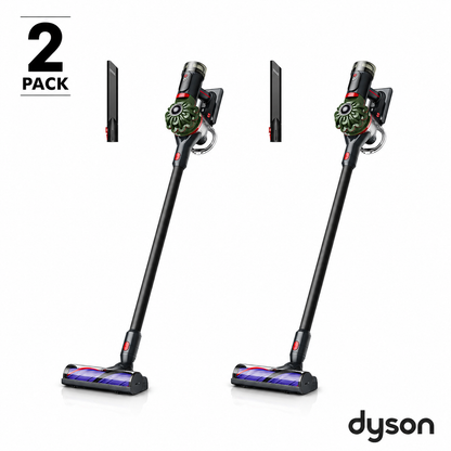 Side angle view of the nickel and purple Dyson V8 Cyclone stick vacuum mounted in its wall dock on a plain wall setup.