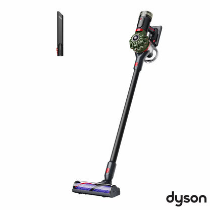 Side angle view of the nickel and purple Dyson V8 Cyclone stick vacuum mounted in its wall dock on a plain wall setup.