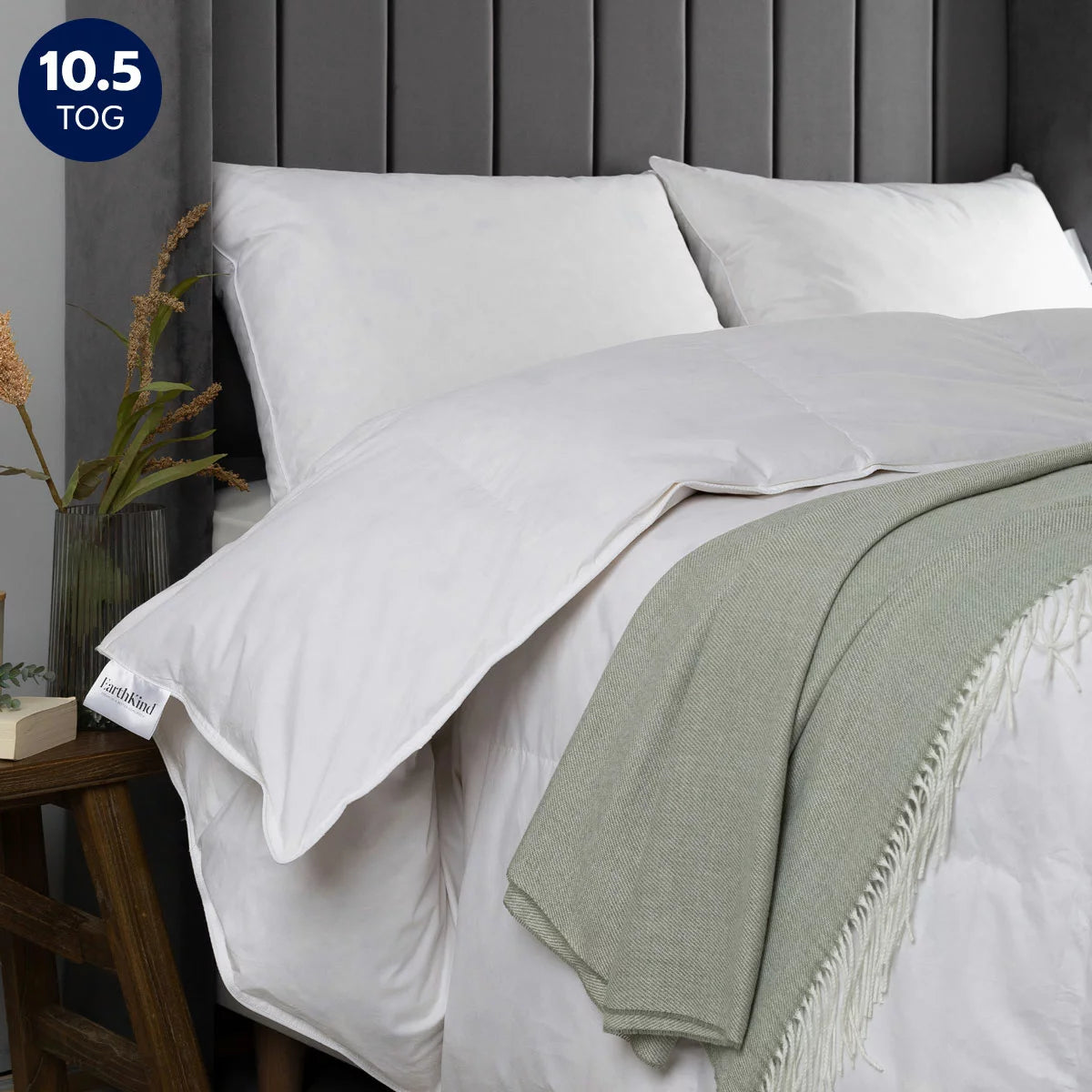 Close-up detail of the white EarthKind recycled feather and down single duvet showing pristine stitching and 230 thread count cotton fabric texture.