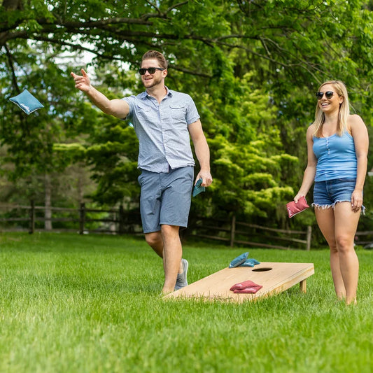 Two Eastpoint Wooden Heritage cornhole boards with a target hole and four red and four blue bean bags.