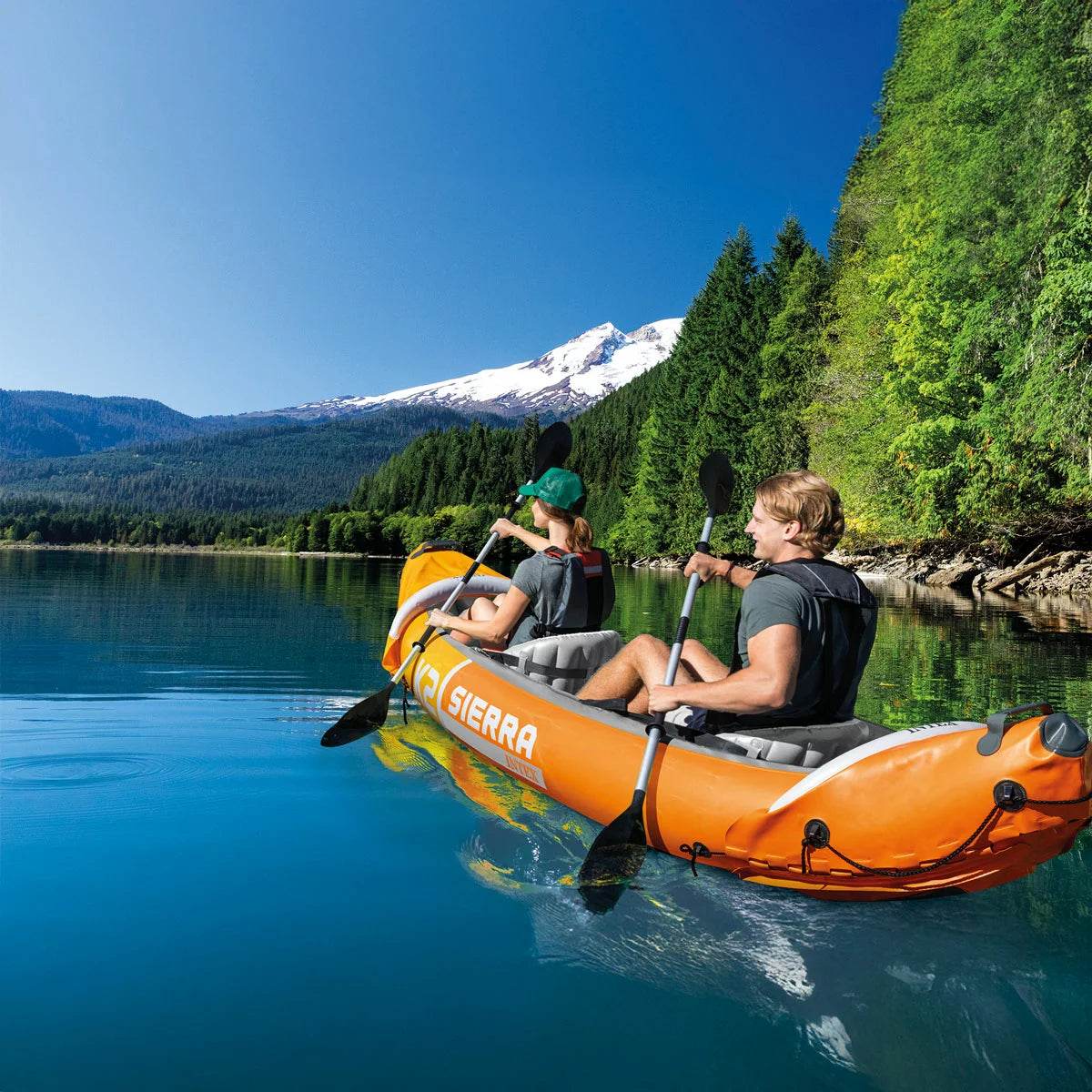 Eddie Bauer 10ft inflatable sit-in kayak with dual-blade paddle on a calm mountain lake.