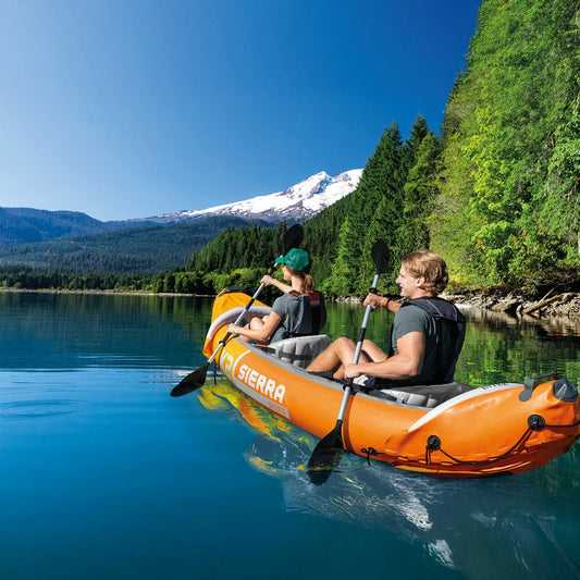 Eddie Bauer 10ft inflatable sit-in kayak with dual-blade paddle on a calm mountain lake.