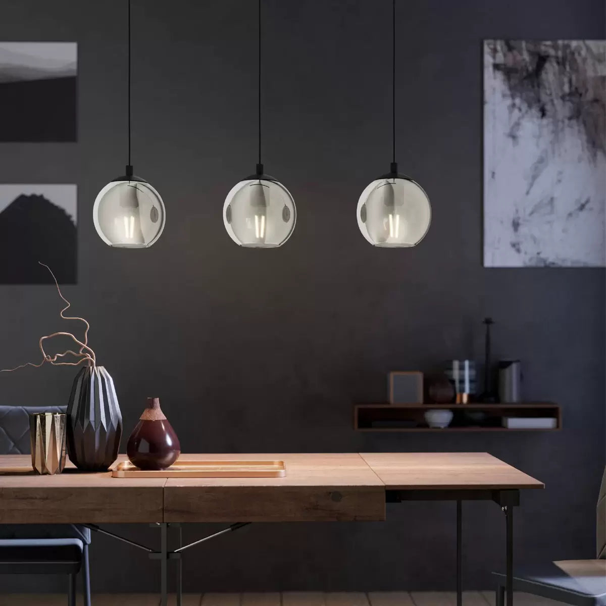 Three smoked glass ball pendant light fixture with modern black frame, suspended for ambient dining room lighting