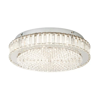 Top-down close-up of the circular Eglo Balparda flush ceiling light featuring polished chrome metal trim and hundreds of small, clear glass crystals refracting light in a modern bedroom setting.