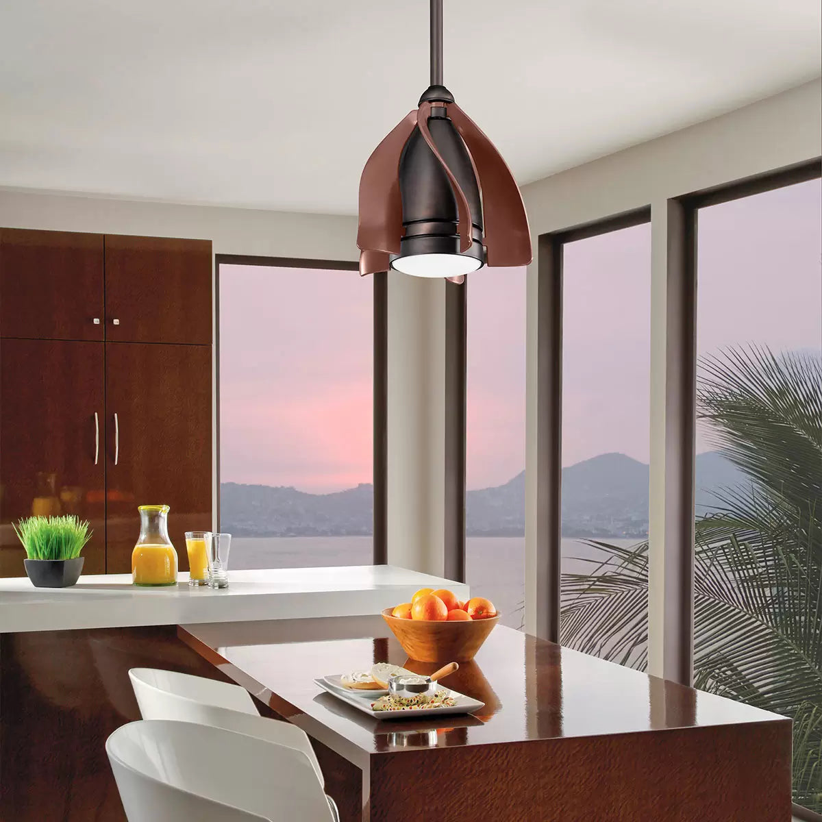 A modern, compact Elstead Terna ceiling fan in a white metal and glass finish, shown installed in a contemporary home office space.