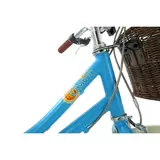 Side profile of the satin Hawaiian blue Elswick Cherish 20-inch kids heritage bike showing the front wicker basket, cream tires, and brown leather-effect saddle on a paved path.