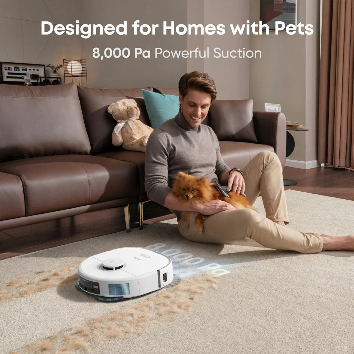 Top-down angle of the white Eufy X10 Pro Omni Robot Vacuum docking into its compact all-in-one cleaning station on a light hardwood floor.