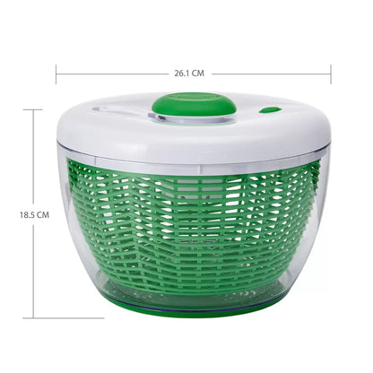 Farberware Pro Pump Salad Spinner with clear bowl spinning fresh green lettuce on a kitchen countertop.