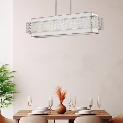 A horizontal five-light Feiss Kenney island chandelier with a sunrise silver geometric steel frame overlaying a white linen shade, suspended above a modern dining table.