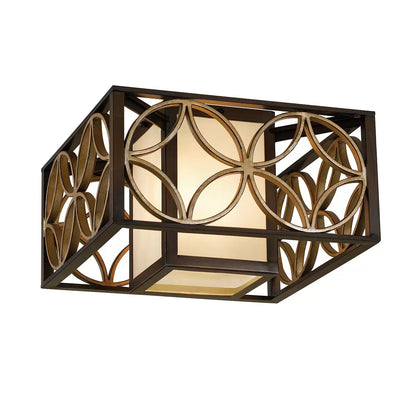 Low-profile Feiss Remy flush-mount ceiling light featuring a dark heritage bronze iron frame, a glittering Parisienne gold metal ring, and a warm bronze organza shade.