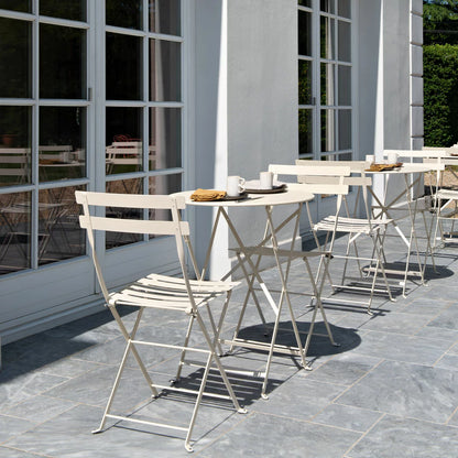 Authentic 3-piece Fermob Bistro set in a sophisticated light brown finish, placed on a modern timber deck.