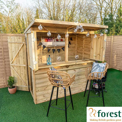 Forest Garden 6ft x 3ft wooden bar shed with open bifold shutters and a wooden bar top, set up in a lush garden.