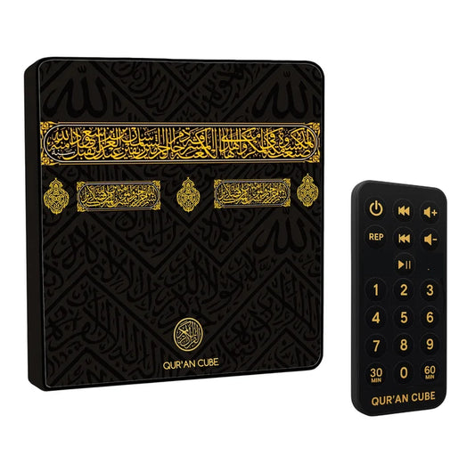 Front view of the sleek white Quran Magnet speaker mounted on a stainless steel refrigerator door with its wireless remote control resting nearby.