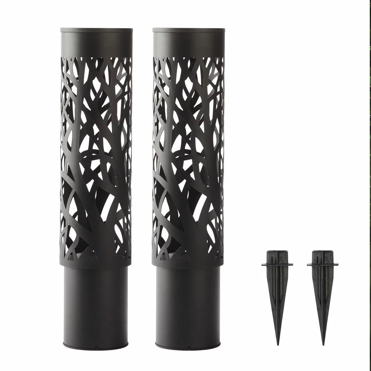 A pair of GTX steel solar bollard lights installed along a garden walkway, featuring intricate cut-out patterns that cast decorative shadows on the ground
