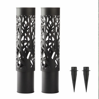 A pair of GTX steel solar bollard lights installed along a garden walkway, featuring intricate cut-out patterns that cast decorative shadows on the ground