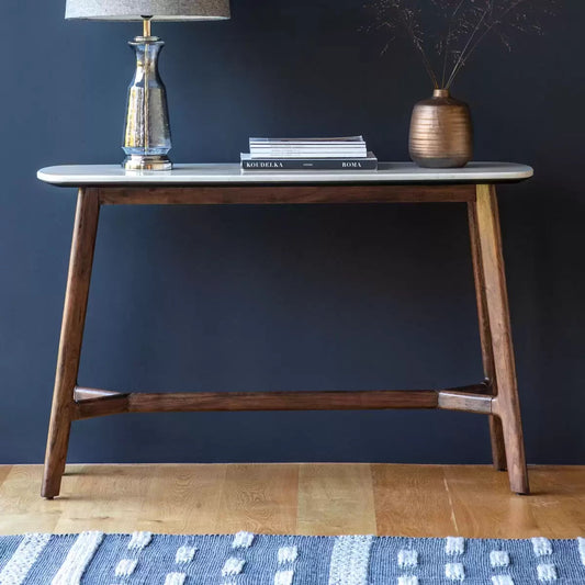 Gallery Barcelona console table featuring a polished white marble top set on a rich solid acacia wood frame placed in a bright modern hallway.