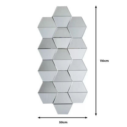 Front view of the 50x110cm Gallery Carina geometric wall mirror showing silver hexagonal honeycomb facets mounted on a neutral wall.