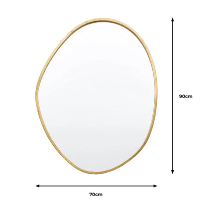 Vertical Gallery Chattenden gold pebble mirror mounted on a neutral living room wall reflecting natural light.