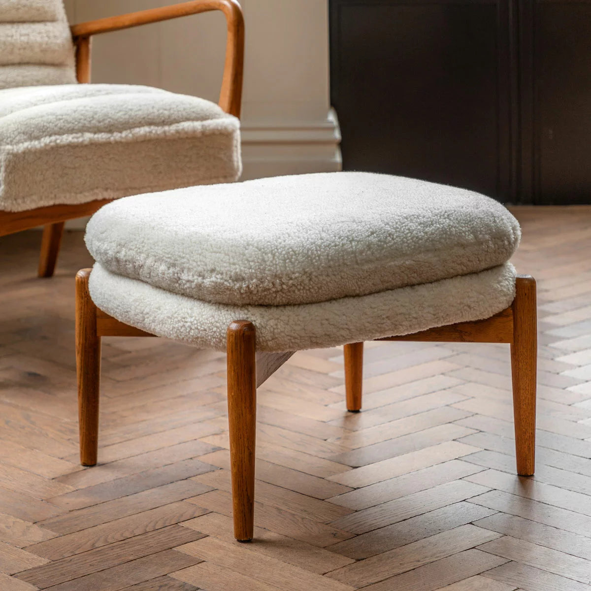 Gallery Datsun Sheepskin Footstool with plush soft upholstery in a modern cosy living room setting